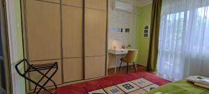 a room with a bed and a desk with a chair at Arianna Apartman in Miskolc
