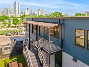 a house with a deck with a roof at Modern Condo with Parking - B in Austin