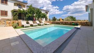 a swimming pool in the backyard of a house at La Casa di Emy in Budoni