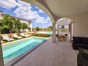 a villa with a swimming pool and a patio at La Casa di Emy in Budoni +15 photos