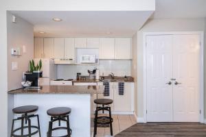 a kitchen with two bar stools and a counter at Mountainside Retreat in Blue Mountains