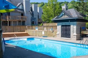 a swimming pool in front of a house at Mountainside Retreat in Blue Mountains