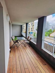 a balcony with chairs and a table on a building at Spacious Near Center Terrace et Parking in Rennes