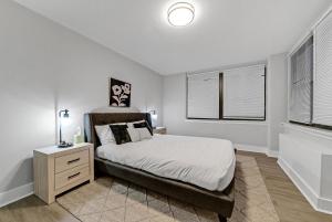 a white bedroom with a bed and a window at Avenue A821 I Cozy And Comfy Philadelphia Stay in Philadelphia +15 photos
