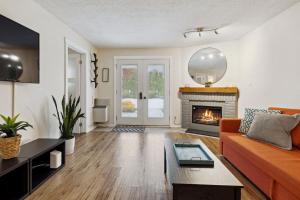 a living room with a couch and a fireplace at Whispering Pines Escape in Collingwood