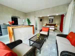 a living room with couches and tables and a kitchen at Villas Coco Mare in Acapulco +6 photos