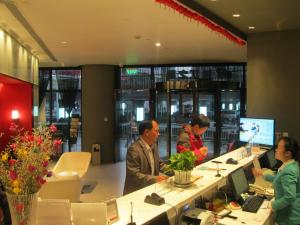 a group of people sitting at a counter in a store at Jinjiang Inn Mianyang Technical Building Flyover in Mianyang