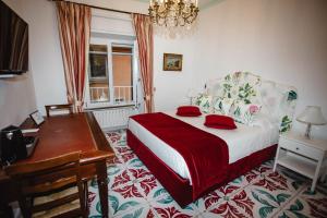 a bedroom with a bed and a table and a desk at Delfini Trevi House in Rome