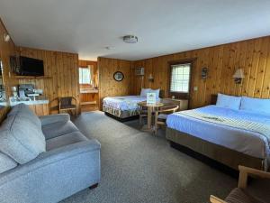 a hotel room with two beds and a couch at Alpine Lodge in Red Lodge
