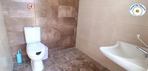 a bathroom with a toilet and a tub and a sink at Camping.Karystos Melodia in Karistos