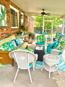 a patio with wicker chairs and a couch and tables at Virginia Beach 2Story with Pool in Virginia Beach
