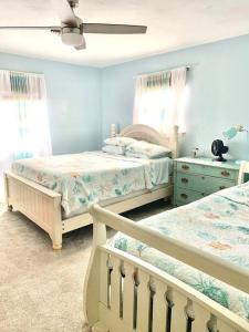 a bedroom with two beds and a ceiling fan at Virginia Beach 2Story with Pool in Virginia Beach +42 photos
