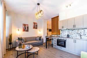 a kitchen and living room with a couch and a table at Lito2Apart in Litochoro