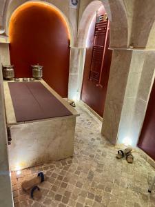 a room with a table and shoes on the floor at La Menara Hotel & SPA in Sidi Bou Saïd