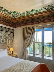 a bedroom with a bed and a window at La Menara Hotel & SPA in Sidi Bou Saïd