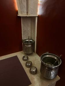 two metal pots and pans sitting on a counter at La Menara Hotel & SPA in Sidi Bou Saïd