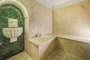 a bathroom with a bath tub and a sink at La Menara Hotel & SPA in Sidi Bou Saïd