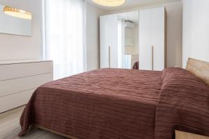 a bedroom with a large bed and a dresser at San Martino Suite in Novara