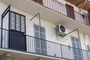 a balcony with a air conditioner on the side of a building at San Martino Suite in Novara