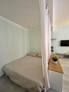 a bedroom with a bed with a curtain over it at Maison Naturalistica - A 5 Fermate Dal Duomo in Milan