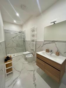 a bathroom with a sink and a toilet and a mirror at Maison Naturalistica - A 5 Fermate Dal Duomo in Milan