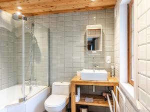a bathroom with a sink and a toilet and a tub at Chalet de standing à Morzine avec jacuzzi, sauna et espace jeux, à proximité des pistes - FR-1-754-2 in Morzine
