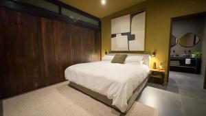 a bedroom with a large white bed in it at Overstory Forest Cabins Ironwood in Cape Town