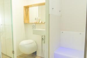 a bathroom with a toilet and a sink and a mirror at OceanSound White in Las Palmas de Gran Canaria +23 photos