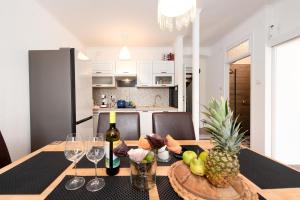 a dining room table with a pineapple and wine glasses at Vila Astra in Matulji