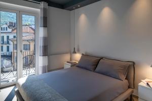 a bedroom with a bed and a balcony at In piazza sul lago in Baveno