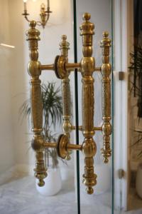 a gold fence in front of a glass door at La Menara Hotel & SPA in Sidi Bou Saïd
