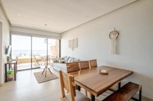 a living room with a wooden table and a couch at Oceanfront condo with terrace in San Francisco