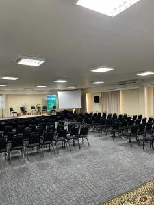 a large room with chairs and a projection screen at Santa Catarina Plaza Hotel in Canoinhas +87 photos