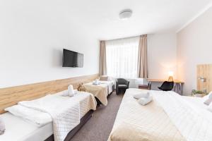 Posteľ alebo postele v izbe v ubytovaní Hotel Sněžné