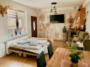 a bedroom with a bed and a living room at Pokoje Gościnne Razem 10 min do plaży in Władysławowo