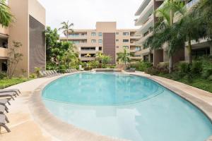 a swimming pool with chairs and a building at Oceanfront condo with terrace in San Francisco