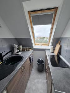 a small kitchen with a sink and a window at Jolie studio a proximité de la plage in Berck-sur-Mer