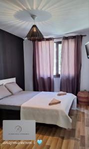 a bedroom with two beds and a chandelier at Atliman Beach Apartment 1 in Kiten