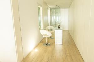 a room with a glass table and a white chair at OceanSound White in Las Palmas de Gran Canaria