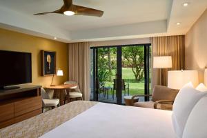 a hotel room with a bed and a television at OUTRIGGER Kāʻanapali Beach Resort in Lahaina