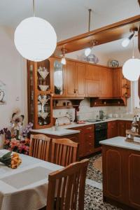 a kitchen with wooden cabinets and a table with chairs at tony's house in Kámpos