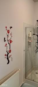 a bathroom with a shower and a tree on the wall at U Magdy dla 3 osób z Parkingiem za ogrodzeniem w Cenie in Borne Sulinowo
