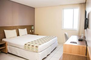 Rúm í herbergi á Stop Way Hotel São Luís