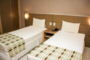 Rúm í herbergi á Stop Way Hotel São Luís