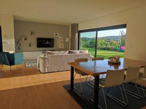 a living room with a table and a couch at Balutinha's house in Barcelos