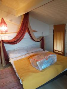 a bed with a bag on it in a room at maison du portail vieil in Vendres