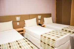 Rúm í herbergi á Stop Way Hotel São Luís