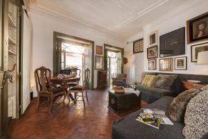 a living room with a couch and a table at Alfama - St Estevão viewpoint | Lisbon Cheese & Wine Apartments in Lisbon