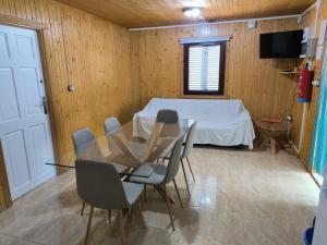a room with a table and chairs and a bed at Casas Rurales Huerto Del Abuelito in Valdeganga