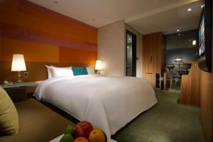 a hotel room with a large bed and a television at Beauty Hotels - Beautique Hotel in Taipei
